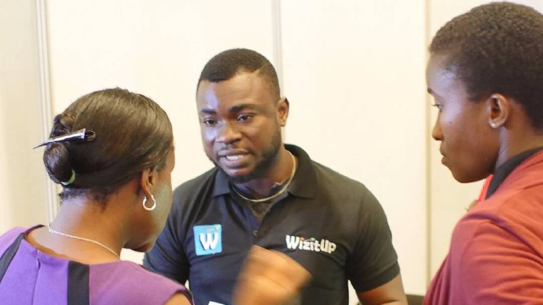Lawal Abiola (Sales), explaining the WizitUp Educational Package to a client